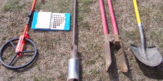 Picture of commonly used septic maintenance tools in a line