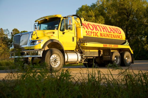 Northland Septic Maintenance truck reflected in a nearby lake