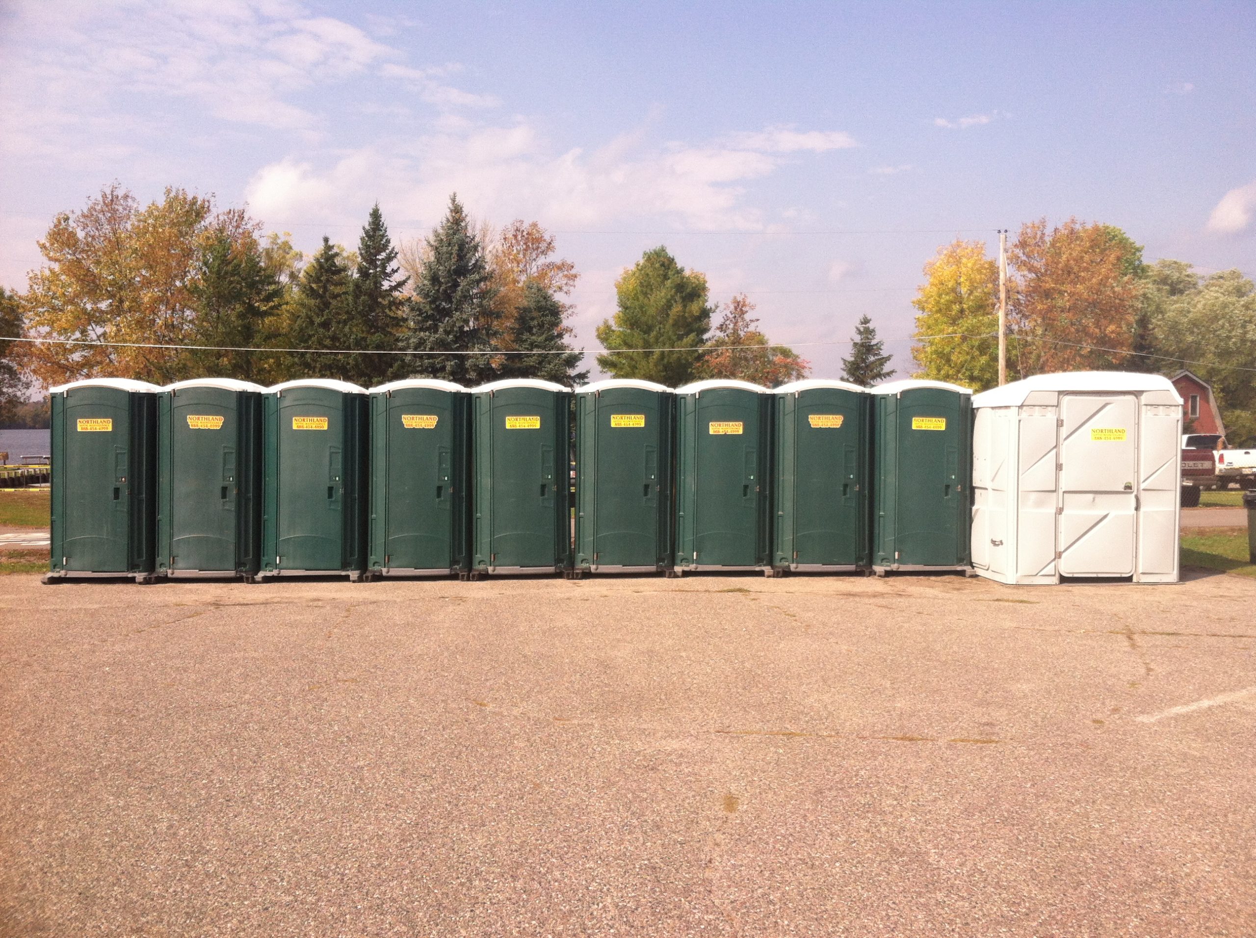Line of portable restrooms with Northland sticker