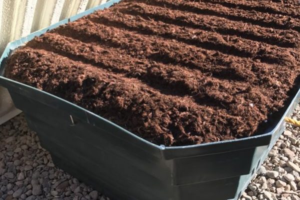 Open bin of dark colored dirt